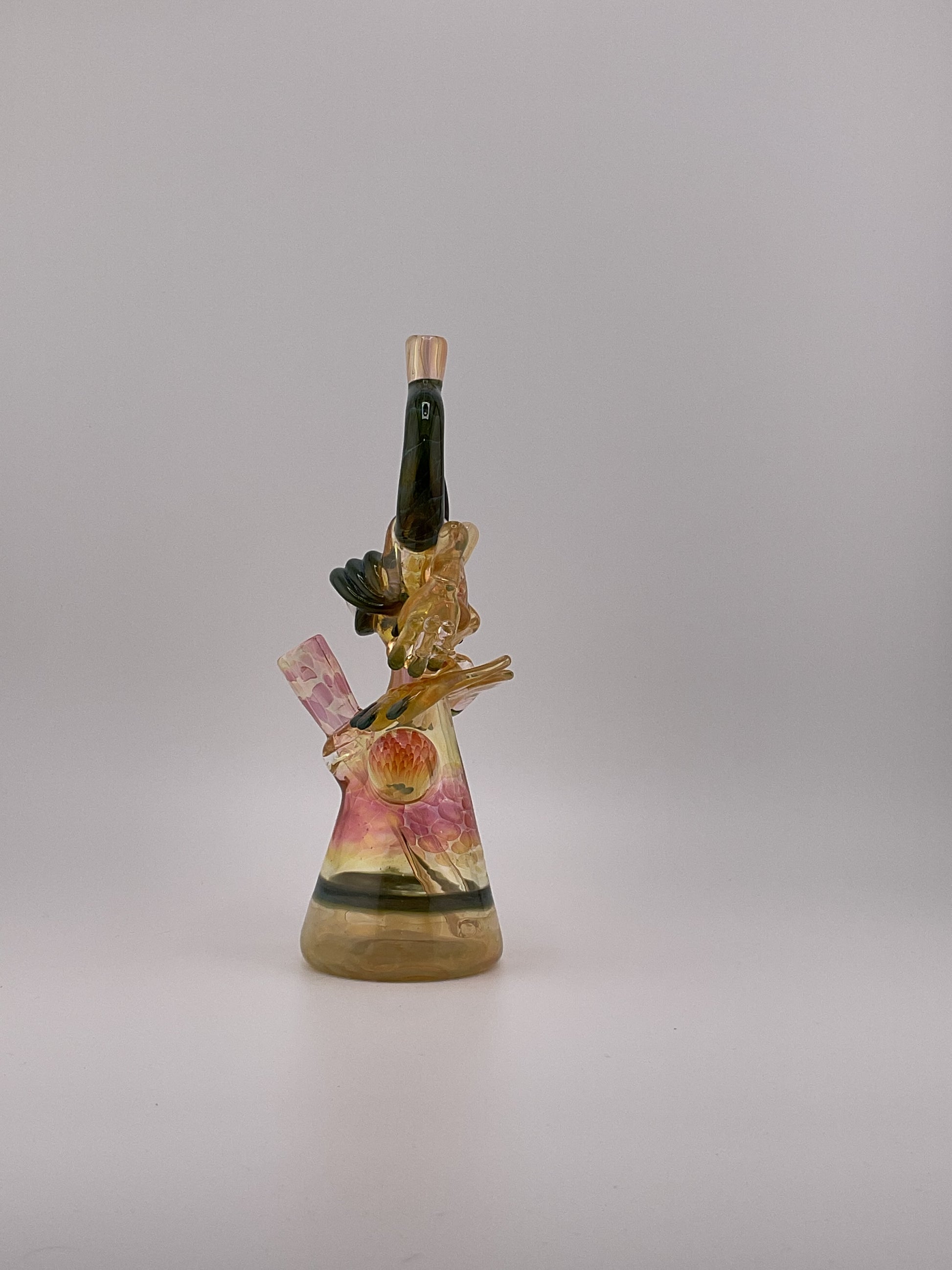 Fumed Jacob jarvis warrior mini tube side view, green horns flower marble pink and yellow hues large eyball with fingernails and toes