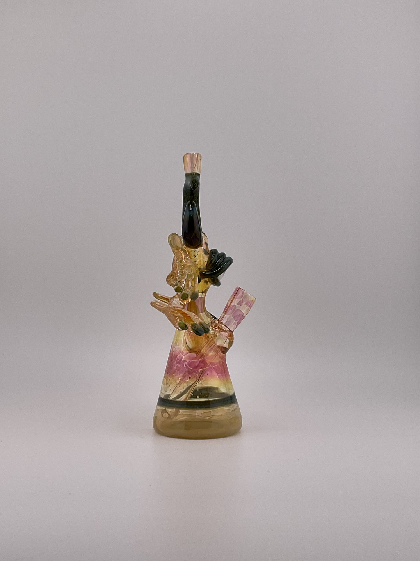 Fumed Jacob jarvis warrior mini tube side view, green horns flower marble pink and yellow hues large eyball with fingernails and toes